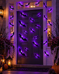 Front door decorated with glowing bats